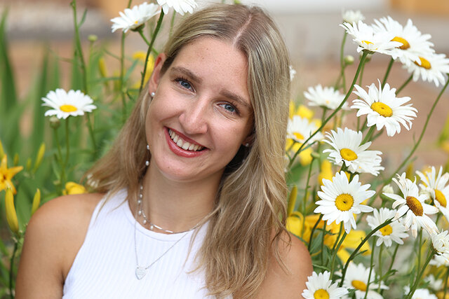 Die künbftige Waidprinzessin steht lächend vor einem Blumenhintergrund aus Margariten. Foto: Celina Jasmin Töppe